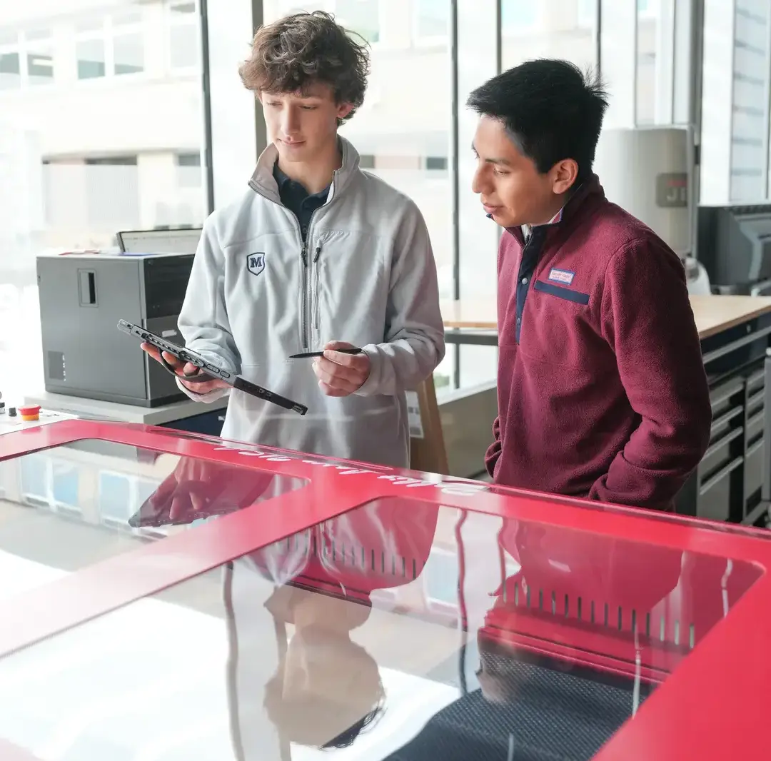 Students working with the laser engraver