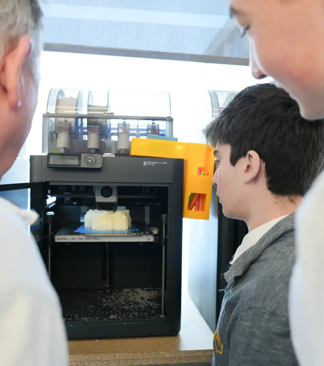 Students working with teacher and 3D video