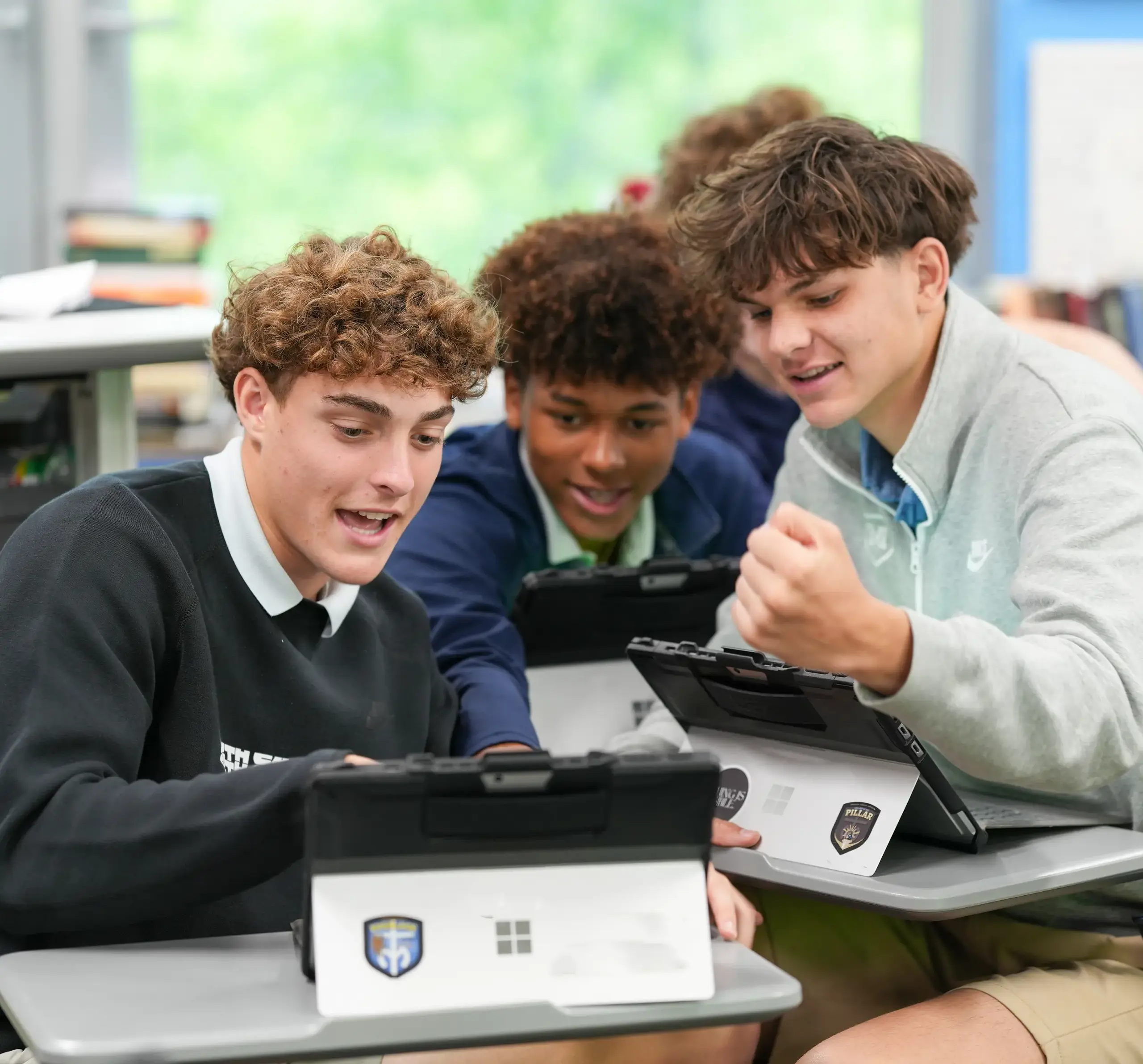 Three students interacting during class