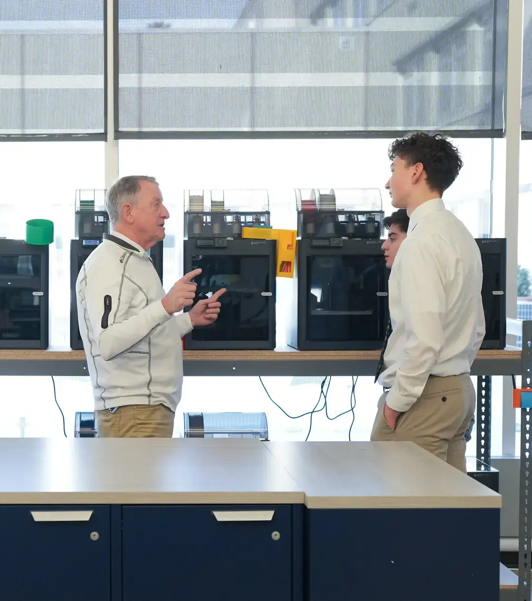 Teacher and student chatting at printer