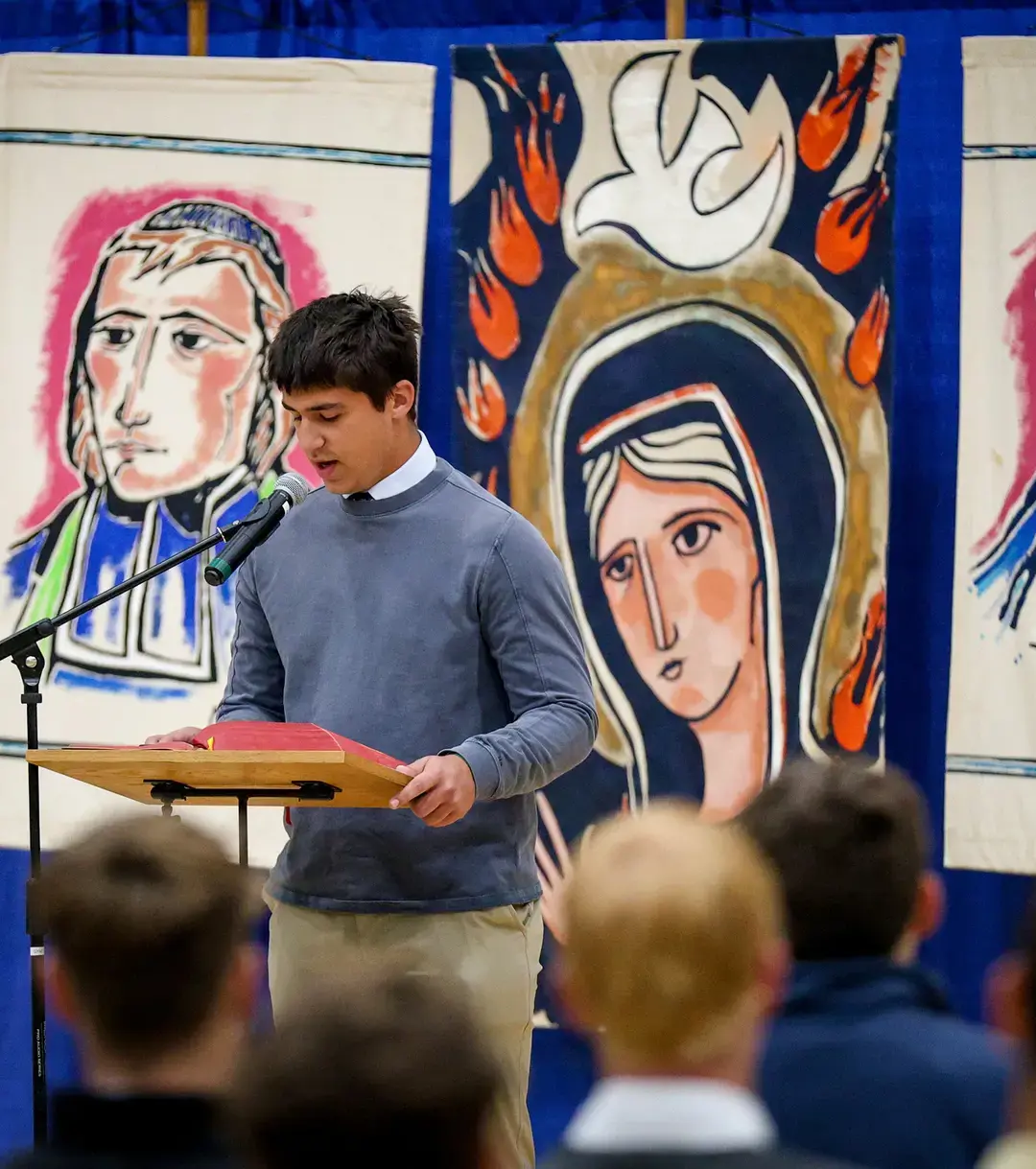 Student reading from behind lecturn