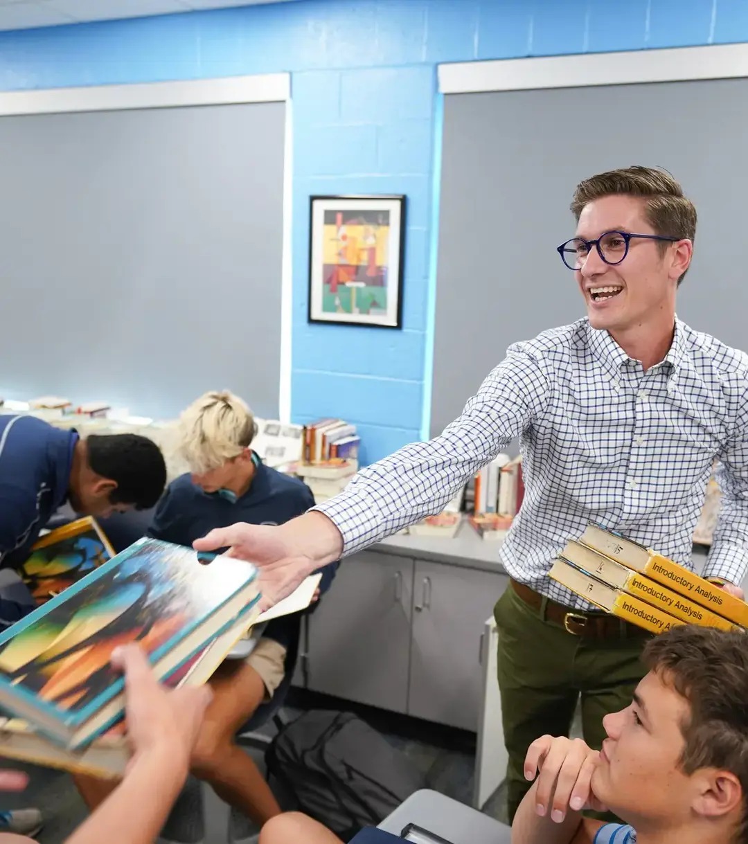 Teacher handing out books