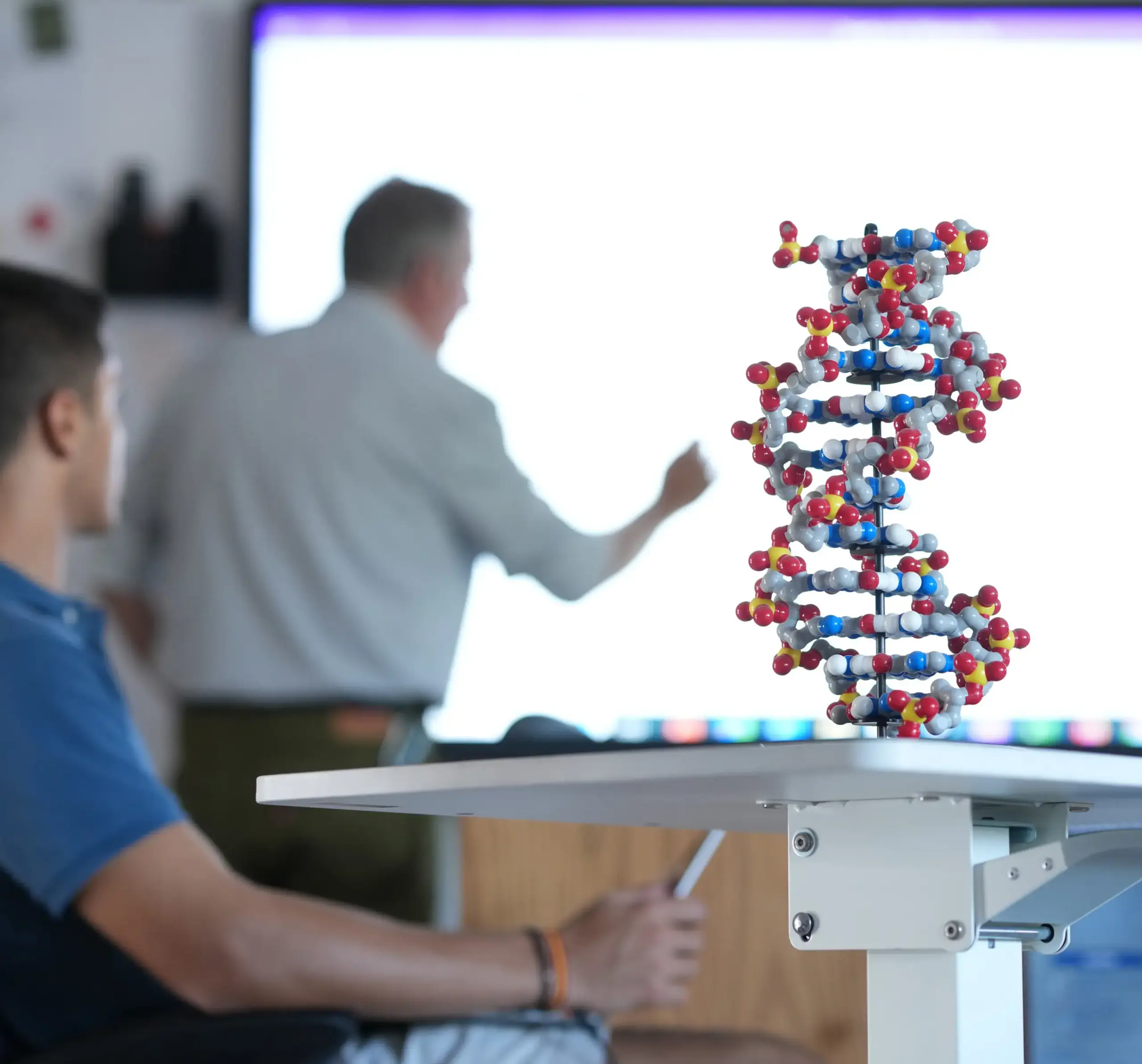 Teacher writing on board in chemistry lesson
