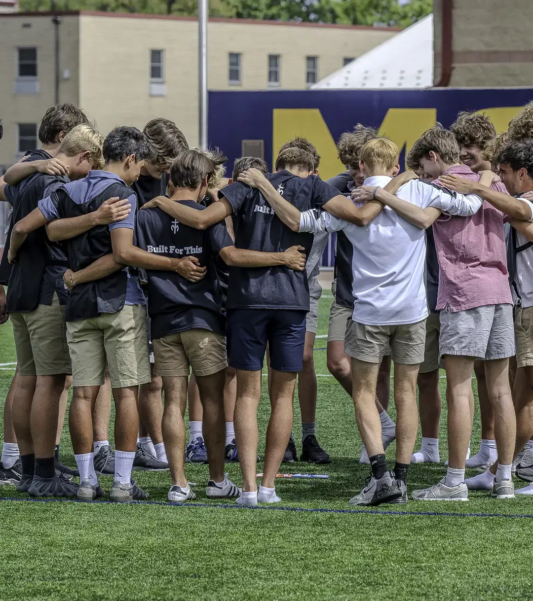 Students in a huddle before the game