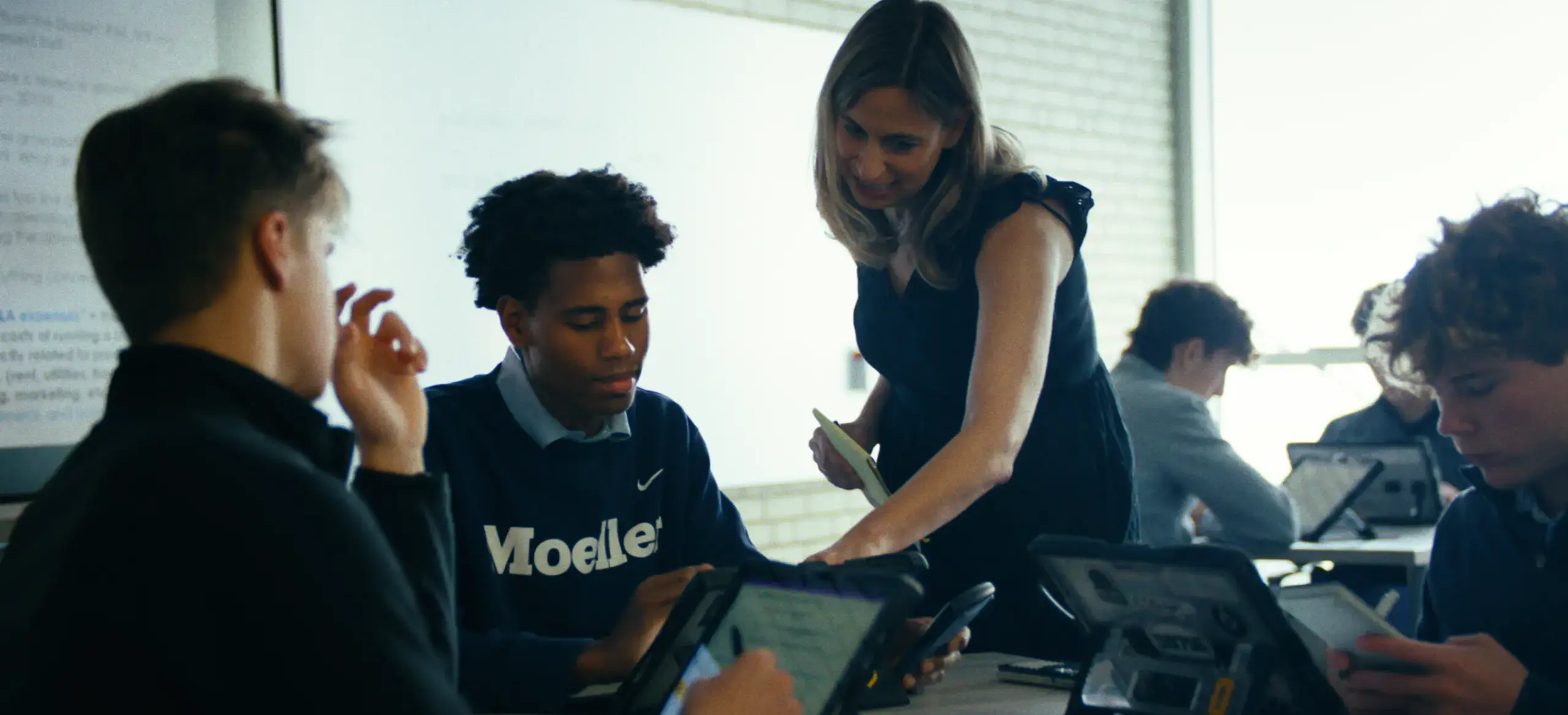 Teacher helping students during lesson